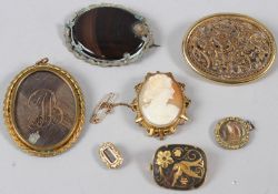 A GROUP OF SEVEN 19TH CENTURY AND LATER MOURNING AND OTHER BROOCHES AND PENDANTS.