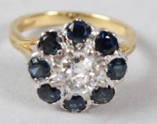 AN 18CT GOLD, SAPPHIRE AND DIAMOND CLUSTER RING, the central diamond within eight sapphires.