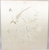 A 20TH CENTURY CHINESE SILKWORK PANEL, embroidered with a floral spray, birds and insects, mounted