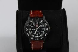 A LUMINOX WRISTWATCH with leather strap.
