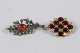 A YELLOW METAL BROOCH, set with seed pearls and red stones, possibly garnets; together with a