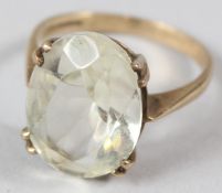 A 9CT GOLD DRESS RING, set with a facet cut oval stone.