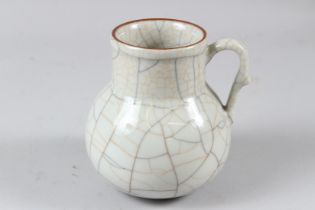 A CHINESE CRACKLE GLAZED PORCELAIN JUG, with loop handle. 13cms high.