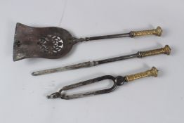 A 19TH CENTURY SET OF THREE FIRESIDE TOOLS, each with ornate cast brass handles, comprising a