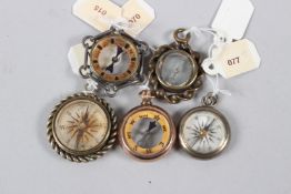 A COLLECTION OF FIVE MINIATURE CHARM COMPASSES.