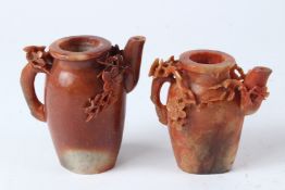 TWO 19TH CENTURY CHINESE CARVED RED SOAPSTONE TEAPOTS. 10cms and 12cms high