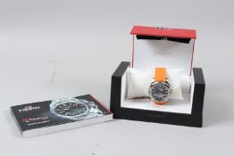 A TISSOT TOUCH TITANIUM TOUCH SCREEN SAPPHIRE CRYSTAL WATCH with orange strap, No. T047 4204 720701,
