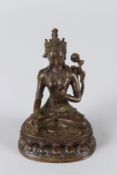 A SMALL CHINESE BRONZE, of a seated female deity. 10cms high.