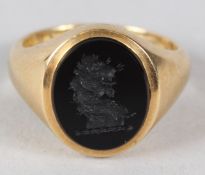 AN 18CT GOLD SIGNET RING, set with a seal. 9gms.