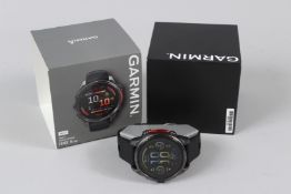 A GARMIN BRAND NEW WRISTWATCH, boxed.