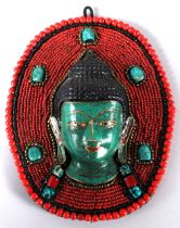 A TIBETAN AUSPICIOUS "GUANYIN HEAD" WALL HANGING. 20cms long.