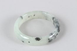 A CHINESE SPECKLED GREEN JADE BANGLE. 7.5cms diameter.