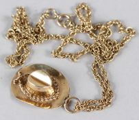 A 9CT GOLD STETSON HAT PENDANT AND CHAIN. 8gms.