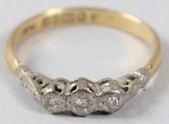 AN 18CT GOLD, PLATINUM AND DIAMOND THREE STONE RING.