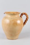A CONTEMPORARY EARTHENWARE JUG, with rope twist handle. 26cms high.