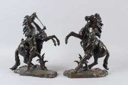 AFTER COUSTOU. A good pair of bronze Marley horses and attendant. Signed. 33cms high.