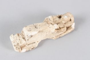 AN EGYPTIAN CARVED LIMESTONE USHABTI. 13.5cms long.
