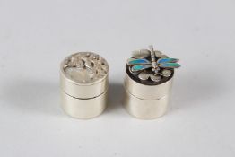 TWO SMALL SILVER CIRCULAR PILL BOXES, one with acorn and oak leaf decoration, the other with a