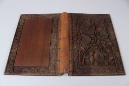 A FINE INDIAN CARVED WOODEN BOOK BINDING. 28cms x 21cms