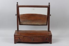 A GEORGE III MAHOGANY BOWFRONT DRESSING TABLE MIRROR, with three drawers to the base. 52cms wide.