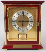 A JAEGER-LECOULTRE ATMOS CLOCK, in a gilt metal and dark red composite case, complete with