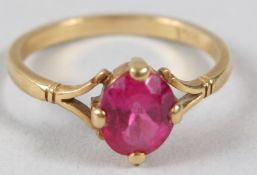 A YELLOW METAL AND RUBY DRESS RING, the shank stamped 18K.