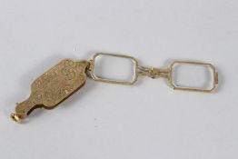 A PAIR OF YELLOW METAL LORGNETTES, with engraved decoration.