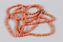 A CORAL BEAD NECKLACE, the barrel clasp stamped 9c. 93cms long.