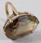 A 9CT GOLD DRESS RING, set with a facet cut oval stone.