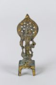 A SMALL GILT BRONZE EASTERN DEITY. 13cms high.