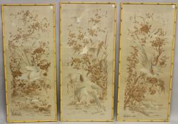 A SET OF THREE 20TH CENTURY CHINESE SILKWORK PANELS, each embroidered with exotic birds amongst