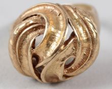 A 9CT GOLD RING, of twisted knot design.