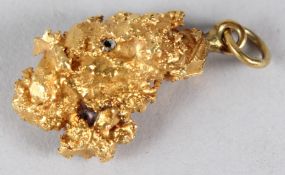 A YELLOW METAL NUGGET PENDANT. 15gms.