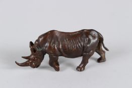 A JAPANESE OKIMONO BRONZE RHINOCEROS. 9cms long.