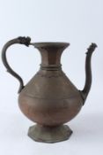 A VERY LARGE INDIAN OR TIBETAN BRASS EWER with dragon shaped handle and spout. 32cms high