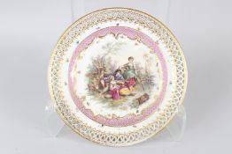 A BERLIN PORCELAIN CIRCULAR DISH, with pierced border, the centre painted with a romantic scene of