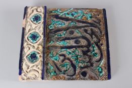 A 19TH CENTURY QAJAR POTTERY TILE, with raised border and calligraphy decoration. 24cms wide.