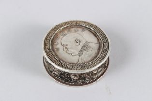 A CHINESE WHITE METAL "COIN" BOX. 5cms diameter.