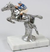 A CHROME HORSE AND JOCKEY CAR MASCOT with blue and white colour.