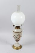 A VICTORIAN OPAQUE GLASS OIL LAMP, painted with a bird on a flowering branch, (cracked). 40cms high,
