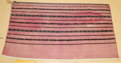 A PERSIAN SADDLE BAG, LATE 19TH CENTURY, pink ground, with striped decoration. 152cms x 84cms.