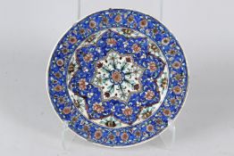 A FINE 19TH CENTURY PERSIAN QAJAR GLAZED POTTERY DISH. 29cms diameter