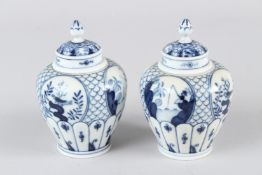 A PAIR OF MEISSEN BLUE AND WHITE PORCELAIN JARS AND COVERS, painted in the Chinese taste. 11cms