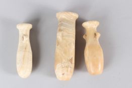 THREE EGYPTIAN ALABASTER PERFUME BOTTLES, Circa. 300BC - 100AD. 10.5cms and 13cms high.