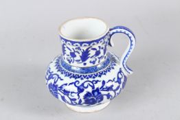 A 19TH-20TH CENTURY TURKISH IZNIK STYLE GLAZED POTTERY JUG. 15cms high