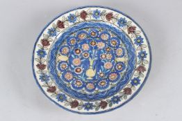 A FINE 19TH CENTURY PERSIAN QAJAR GLAZED POTTERY DISH. 29.5cms diameter