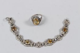 A CONTINENTAL SILVER RING, set with a pale yellow stone, stamped 835; together with a matching