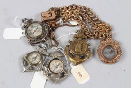 A COLLECTION OF FIVE MINIATURE CHARM COMPASSES.
