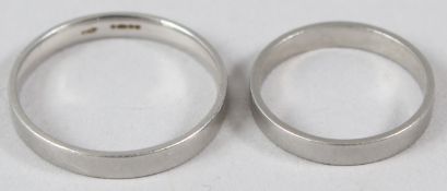 A PLAIN PLATINUM WEDDING RING; together with a similar smaller wedding band, (unmarked).