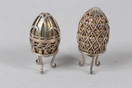 A SILVER MOUNTED EGG BOX ON STAND; together with a similar decorative egg shaped box with stand.